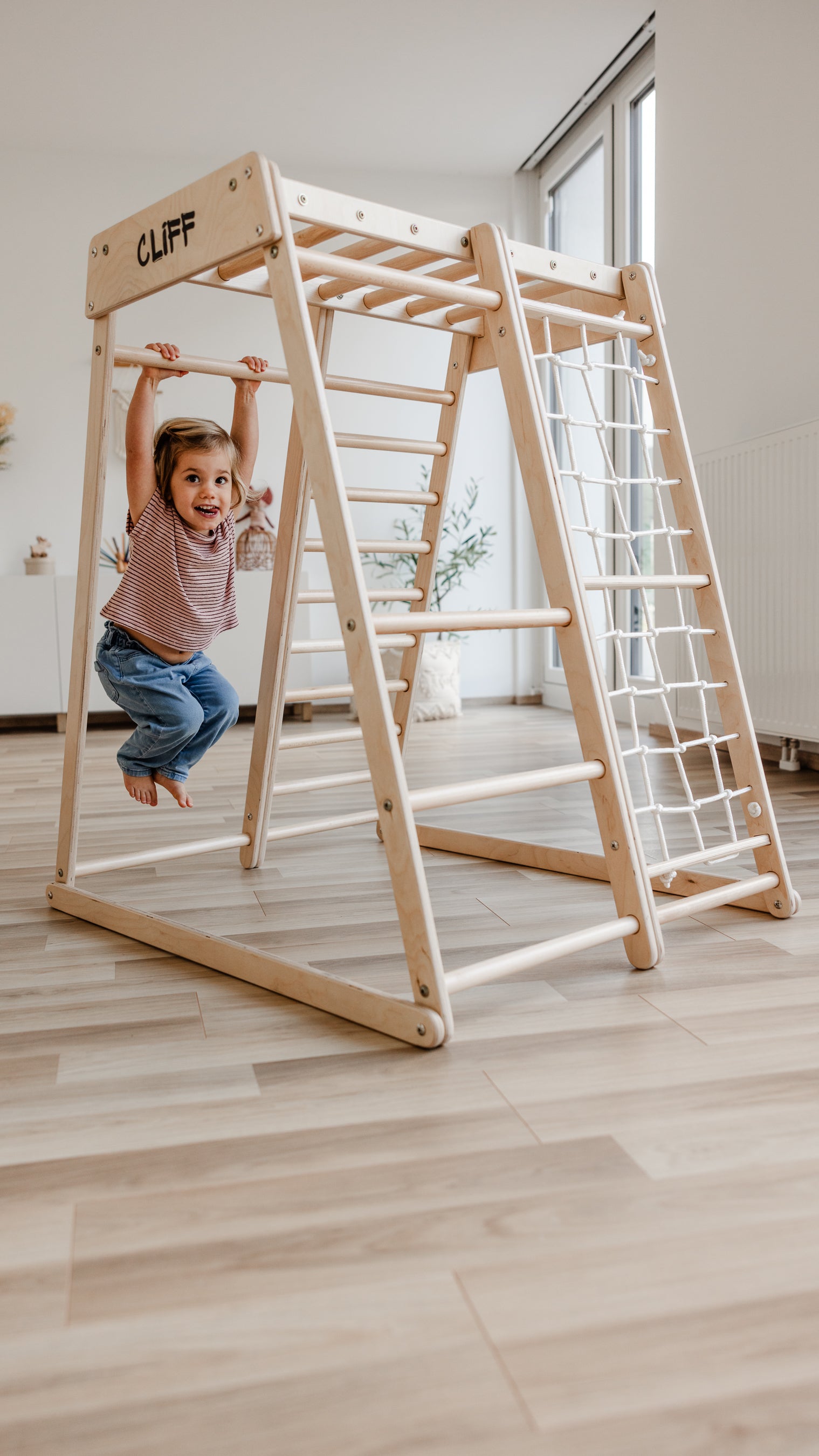Kind klettert am CLIFF Compact Indoor-Klettergerüst aus Holz