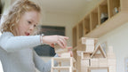 Kind spielt mit dem Just Blocks BASIC Small Holz-Lernsystem